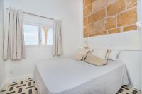 A bed or beds in a room at Beachfront Villa Es Clot by Sealand Villas