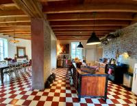 a kitchen with a checkered floor and a kitchen with a counter at La Motte in Louroux-de-Bouble