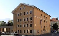 a large building with a car parked in front of it at Hotel Engl in Innsbruck