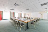 a conference room with a long table and chairs at Hotel am Schloß Apolda in Apolda