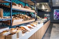 a bakery with lots of bread and pastries on display at Van der Valk Cuijk - Nijmegen in Nijmegen