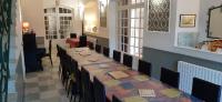 a room with a long table with chairs in it at Moulin de Chappes in Chappes