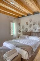 A bed or beds in a room at Ca' dei Battuti Apartments