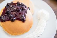 a pancake with chocolate and blueberries on a plate at MO2 Westown Hotel Iloilo in Iloilo City