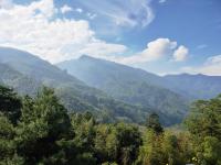 a view of a mountain range with trees and mountains at Kingtaiwan Hotel in Lugu Lake