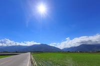 an empty road with the sun in the sky at 蒙地拿民宿 l 全自助入住 in Taitung City
