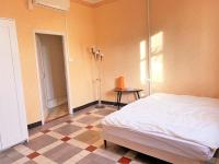 a bedroom with a bed and a tiled floor at LA PROVENÇALE in Orange