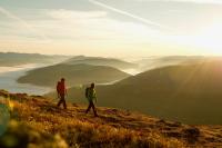 two people walking on top of a hill with a view at Penthouse Skyview im Natur-Erlebnispark Bad Kleinkirchheim in Patergassen