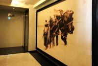 a large painting on a wall in a hallway at The Galerie Hotel in Taichung