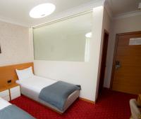 a hotel room with a bed and a window at Holiday Resort in Velika Slatina
