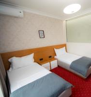 a hotel room with two beds and a window at Holiday Resort in Velika Slatina