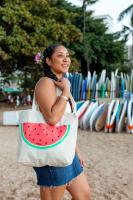 a woman holding a bag with a slice of watermelon at VIVE Hotel Waikiki in Honolulu