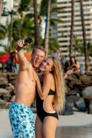 a man and a woman standing on the beach at VIVE Hotel Waikiki in Honolulu