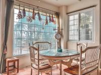 a dining room with a table and chairs and windows at Euro Country Villa in Ren&#39;ai