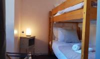 a bedroom with a bunk bed and a desk with a lamp at Hôtel Terminus in Luz-Saint-Sauveur