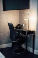 a black desk with a chair and a telephone at Amirauté in La Baule