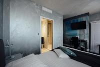 a bedroom with a bed and a television on the wall at Amirauté in La Baule