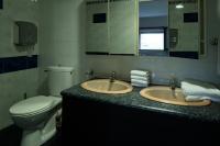 a bathroom with two sinks and a toilet and a mirror at Dortoirs Rocade 2 in Pamiers