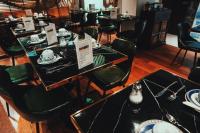 a dining room with tables and chairs with dishes on them at Waldorf Montparnasse in Paris