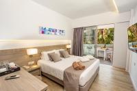 A bed or beds in a room at Akti Imperial Deluxe Resort & Spa Dolce by Wyndham