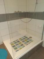 a shower stall with a glass enclosure with at Chez Frédéric et Alexandre in Bennwihr