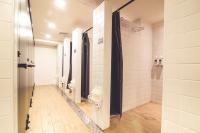 a bathroom with two urinals and stalls with toilets at Ahiruyah Guesthouse in Kaohsiung