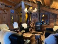 a log cabin living room with a wood stove at La Bournerie in Le Grand-Bornand