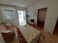Televízia a/alebo spoločenská miestnosť v ubytovaní Apartments Slavica
