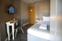 a hotel room with a bed and a desk and a television at So&sol boutique Hotel, Tuzla in Tuzla