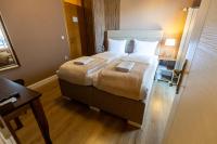 a hotel room with a bed with two towels on it at So&sol boutique Hotel, Tuzla in Tuzla