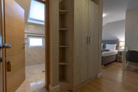 a room with a closet with a shower and a bedroom at So&sol boutique Hotel, Tuzla in Tuzla