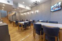 a dining room with tables and blue chairs at So&sol boutique Hotel, Tuzla in Tuzla