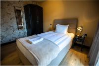 a bedroom with a bed with a towel on it at So&sol boutique Hotel, Tuzla in Tuzla