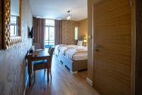 a hotel room with a bed and a desk and a door at So&sol boutique Hotel, Tuzla in Tuzla
