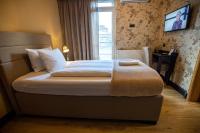 a bedroom with a large bed with a window at So&sol boutique Hotel, Tuzla in Tuzla