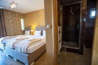 a hotel room with a bed and a shower at So&sol boutique Hotel, Tuzla in Tuzla