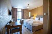 a hotel room with a bed and a table and a desk at So&sol boutique Hotel, Tuzla in Tuzla