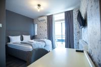 a small hotel room with a bed and a table at So&sol boutique Hotel, Tuzla in Tuzla
