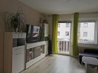 a living room with a television and a balcony at Nina´s Appartement Bad Mitterndorf in Bad Mitterndorf