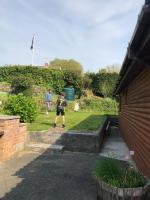 a couple of people standing in a yard at East Crinnis Log Cabin in Par