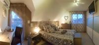 a bedroom with a bed and a dresser and a window at La Villa Esterel &amp; SPA in Village-Neuf
