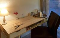 a wooden desk with a lamp and a plate on it at La Villa Esterel &amp; SPA in Village-Neuf
