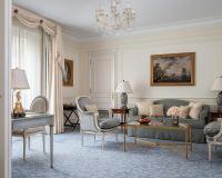 a living room with a couch and a table at Four Seasons Hotel George V Paris in Paris