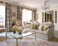 a living room with a couch and a table at Four Seasons Hotel George V Paris in Paris