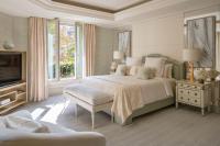 a bedroom with a large bed and a tv at Four Seasons Hotel George V Paris in Paris