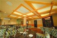 a restaurant with tables and chairs in a room at Akhil Classic in Trivandrum