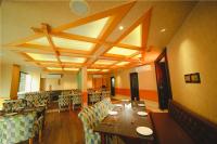 a dining room with tables and chairs in a restaurant at Akhil Classic in Trivandrum