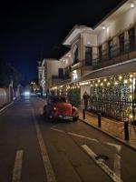an old car driving down a street at night at Apartament The Bricks 1903 in Bistriţa