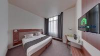 a hotel room with a bed and a tv at Campanile Orléans Centre Gare in Orléans