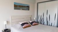 a bedroom with a white bed with two pillows at Les Yeux Bleus Bed &amp; Breakfast in Noirmoutier-en-l&#39;lle